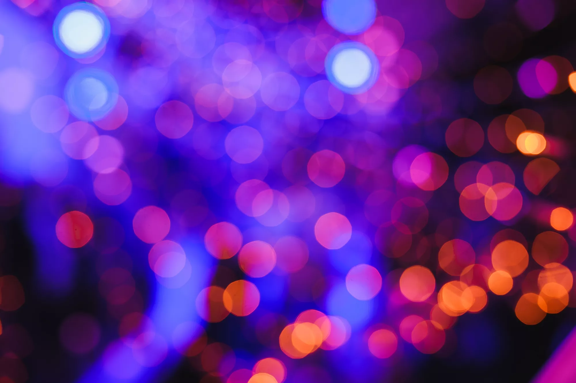 Abstract blue purple orange flares against black background